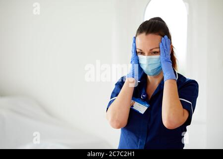 Stressed Nurse at work Stock Photo