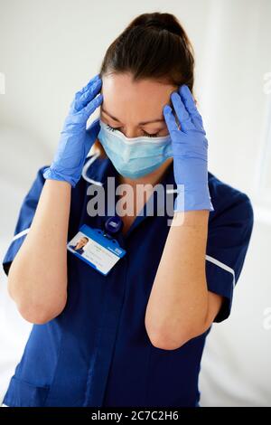 Stressed Nurse at work Stock Photo