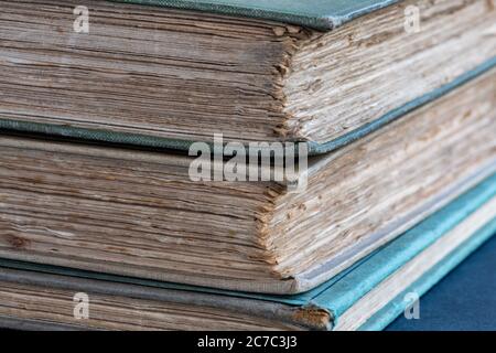 Pile of old books with rough uncut or untrimmed edges known as deckle edges Stock Photo