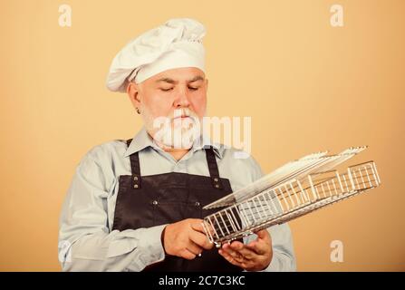 Cooking with passion. senior man in chef hat. cook men with beard. cooking utensils for barbecue. he prefer grill food. Picnic and barbecue. Kitchen rules. prepare dinner for family. Family weekend. Stock Photo