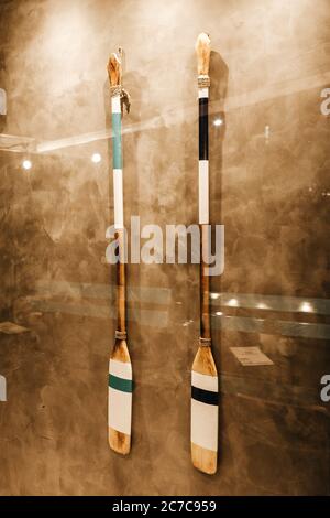 Vertical shot of two wooden oars hanging on a wall Stock Photo
