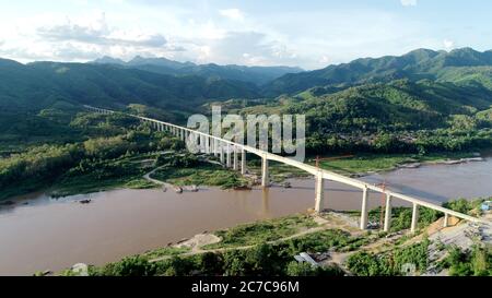 (200716) -- VIENTIANE, July 16, 2020 (Xinhua) -- Aerial photo taken on July 15, 2020 shows the view of the Ban Ladhan Mekong River Super Major Bridge located some 230 km north of Vientiane, Laos. The Laos-China Railway Co., Ltd. (LCRC), a joint venture based in Lao capital Vientiane in charge of the construction and operation of the railway, told Xinhua on Thursday that, all its beams of the two cross-Mekong River bridges have been installed. (CREC-8/Handout via Xinhua)