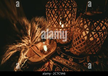 Closeup shot of two wooden lampshades with lightbulbs inside them on a table Stock Photo