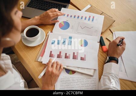 Close up business colleagues working on new project with diagrams in office Stock Photo