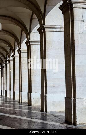 Pillars along the 'Praca de Commercio' Commerce square of Lisbon at sunrise Stock Photo