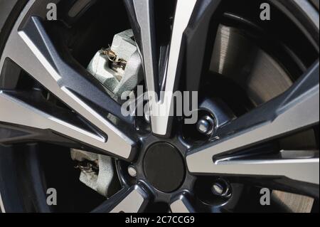 Shiny car wheel with alloy rims and new break system Stock Photo