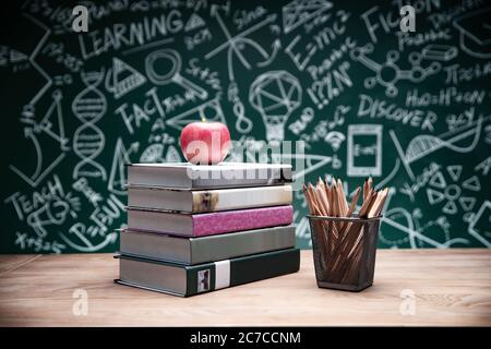 Tables in front of the blackboard drawing books and stationery Stock Photo