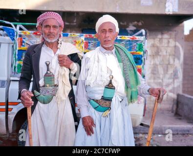 Portrait of two Yemeni men wearing traditional clothing and displaying ...