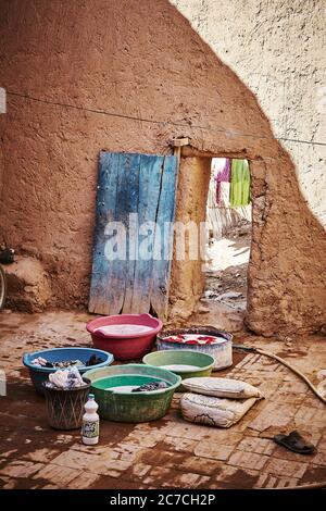 Vertical shot of the laundry done the old way in plastic basins in Tamegroute, Morocco Stock Photo