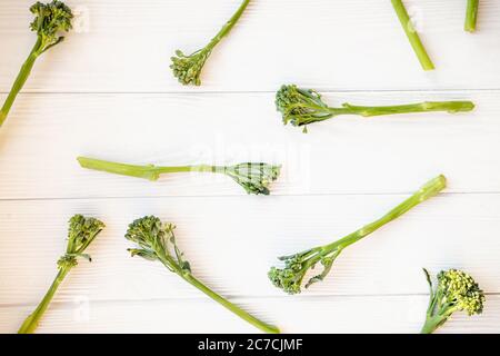 Raw broccolini on white table. Stock Photo