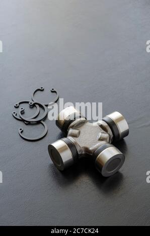 Cross joint for propeller shaft and set of circlips. Trade Auto parts, car service. Automotive industry. Selective focus. Stock Photo