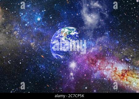 Earth and galaxies in space. Science fiction art. Elements of this image furnished by NASA. Stock Photo