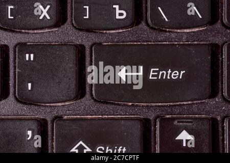 A computer keyboard. Focus on enter button. Black background Stock Photo