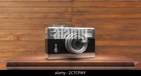 Photo camera vintage style. Retro old fashioned camera on wooden background, copy space. 3d illustration Stock Photo
