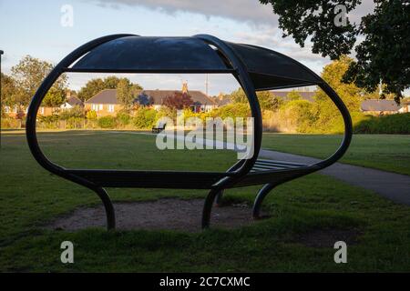 St Helens Church . Boultham Park Lincoln, Boultham Park, Lincoln, Lincolnshire, seating, shelter, area, park bench, picnic shelter, woodland, metal. Stock Photo