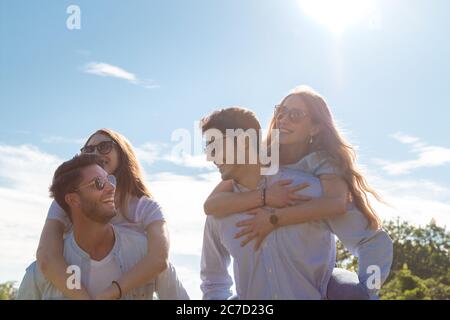 group of young friends walking in a park while smiling - happy young group of friends Stock Photo