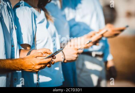 close up  photos of group of young friends using smartphone outdoor -  close-up photos of hands using mobile phones outside Stock Photo