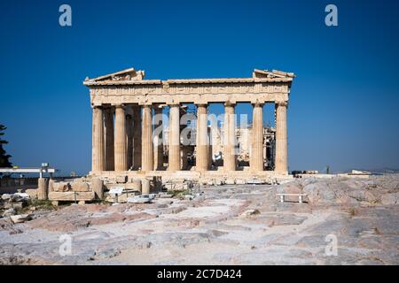 The Parthenon of the Acropolis in Athens Greece shines in the warm sun before a blue sky and nobody is present. Stock Photo