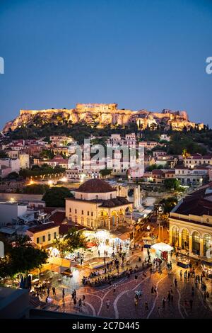 The historical Acropolis in Athens Greece is enthroned above the lively old town Plaka with scenic lighting at night. Stock Photo