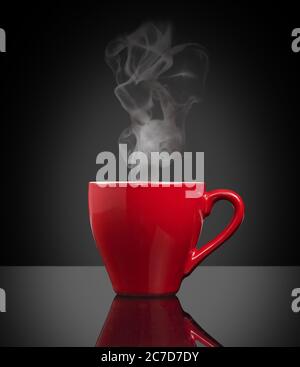 red cup of steamy coffee on black background Stock Photo