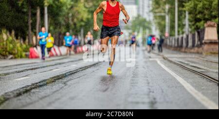 man athlete runner leader of marathon race run in rainy weather Stock Photo