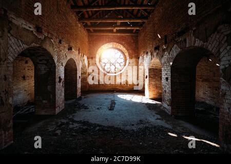 Round stained glass window in old abandoned castle Stock Photo