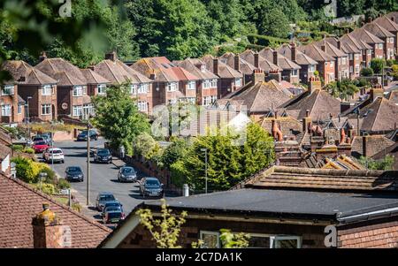 Old Town, Eastbourne, East Sussex, England. A view over the rooftops of a post-war 1950's suburban housing estate backed by ancient woodland. Stock Photo