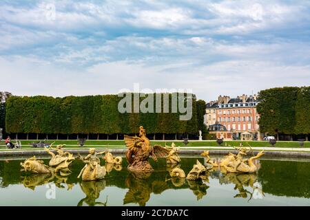 Versailles, France - August 27, 2019 : Dragon fountain in beautiful gardens of famous Versailles palace. The Palace of Versailles was a royal chateau. Stock Photo