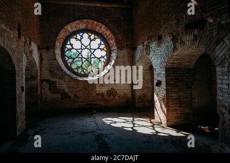 Round stained glass window in old abandoned castle Stock Photo