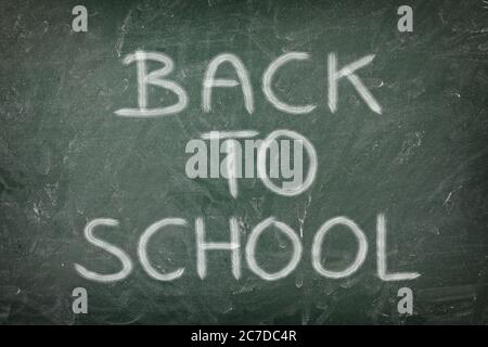 Back to school message written on dirty green chalk blackboard Stock Photo