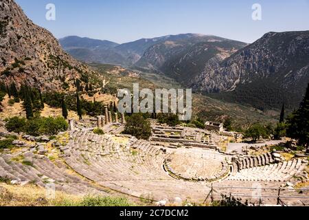 The historic theatre of the ancient city of Delphi in Greece overlooking the surrounding hills in summer. Stock Photo