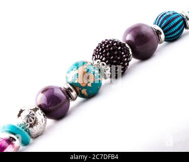 Strand of chunky colored beads laid diagonally across image Stock Photo