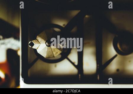 Overhead shot of an old silver coffee pot on a two-burner stove Stock Photo