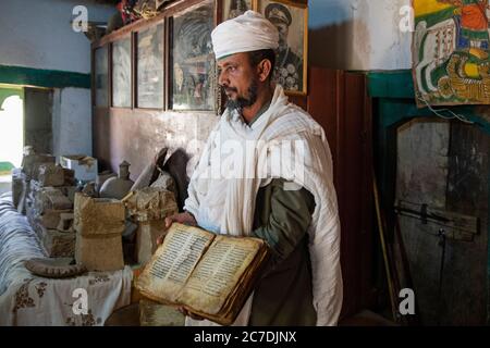 Ethiopian Orthodox Priest With An Old Bible In Nakuto Lab Rock Church ...