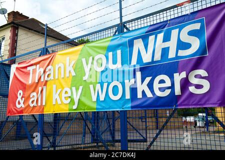 Rainbow banner attached to a fence, in gratitude to all NHS medical staff and keyworkers who are working during the UK Coronavirus pandemic crisis. Stock Photo