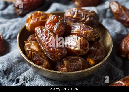 Organic Dry Red Dates in a Bowl Stock Photo