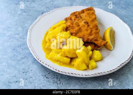 Potato Salad with Mustard, Turmeric and Curry Sauce. Served with Schnitzel. Traditional Dish. Stock Photo