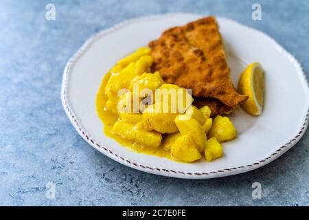 Potato Salad with Mustard, Turmeric and Curry Sauce. Served with Schnitzel. Traditional Dish. Stock Photo