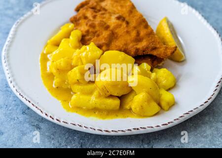 Potato Salad with Mustard, Turmeric and Curry Sauce. Served with Schnitzel. Traditional Dish. Stock Photo