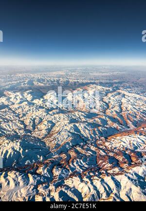 Aerial View from an Airplane. Flying above Beautiful Land at Sunrise. Stock Photo