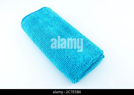 Light blue microfiber fabric lying in the middle, isolated on a white background, top view. Stock Photo