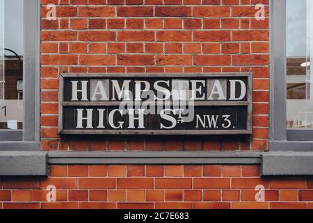 Street name sign on a red brick building on Hampstead High Street, Hampstead, London, UK. Stock Photo