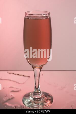 Glasses with red wine on a background reflection, pink background Stock Photo