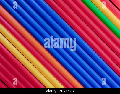 Colorful plastic tubes straws blue center diagonal background Stock Photo