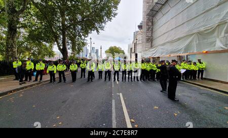 Rows of police lined up on central London street preparing for crowd control during extinction rebellion protest Stock Photo