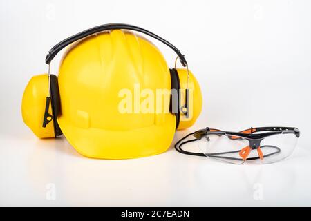 Safety glasses and a work helmet. Workwear for production workers. Light background. Stock Photo