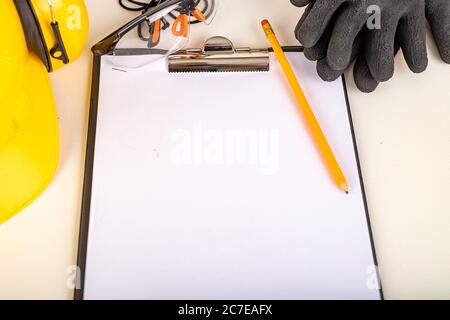 White sheet on a rigid base with a pencil. Work accessories for production workers. Light background. Stock Photo