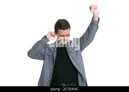 A young man in a Manatee shirt, black t-shirt and trousers, isolated on white The main task is completed Yeah I did it I reached so long desired success Happy excited cheerful joyous Stock Photo