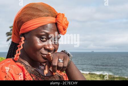 African woman points to you not to forget history but in a peaceful way, memories from old part of Ghana colonial era in Sekondi-Takoradi Ghana West A Stock Photo