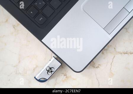 Infecting a laptop with a Computer Virus via an usb stick, free copy space Stock Photo